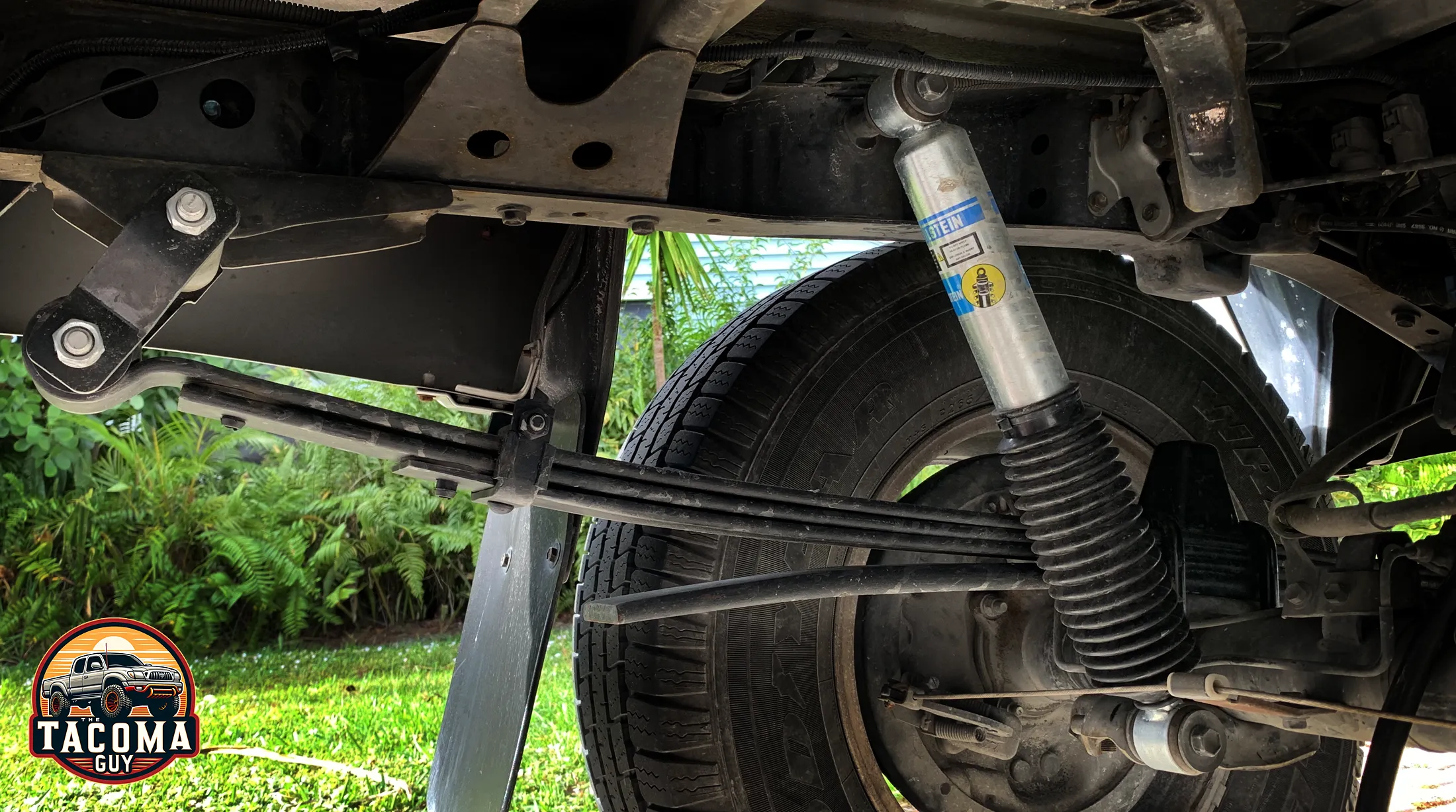 Close-up photo of a Bilstein 5100 shock absorber and General Springs 4x4 / Prerunner Heavy Duty rear leaf spring, with 4(3/1) leaves (part number 90-237HD)