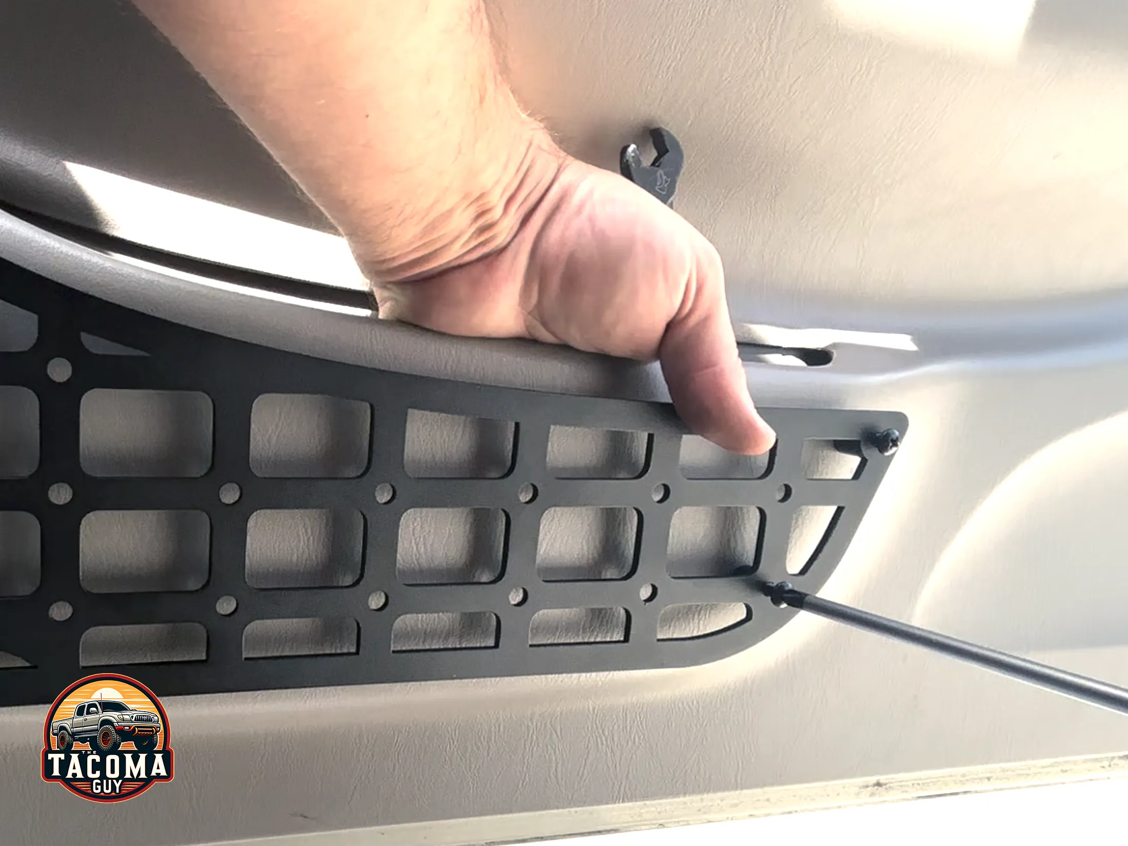 Holding the nut in place while tightening the bolt on the TEQ MOLLE panel