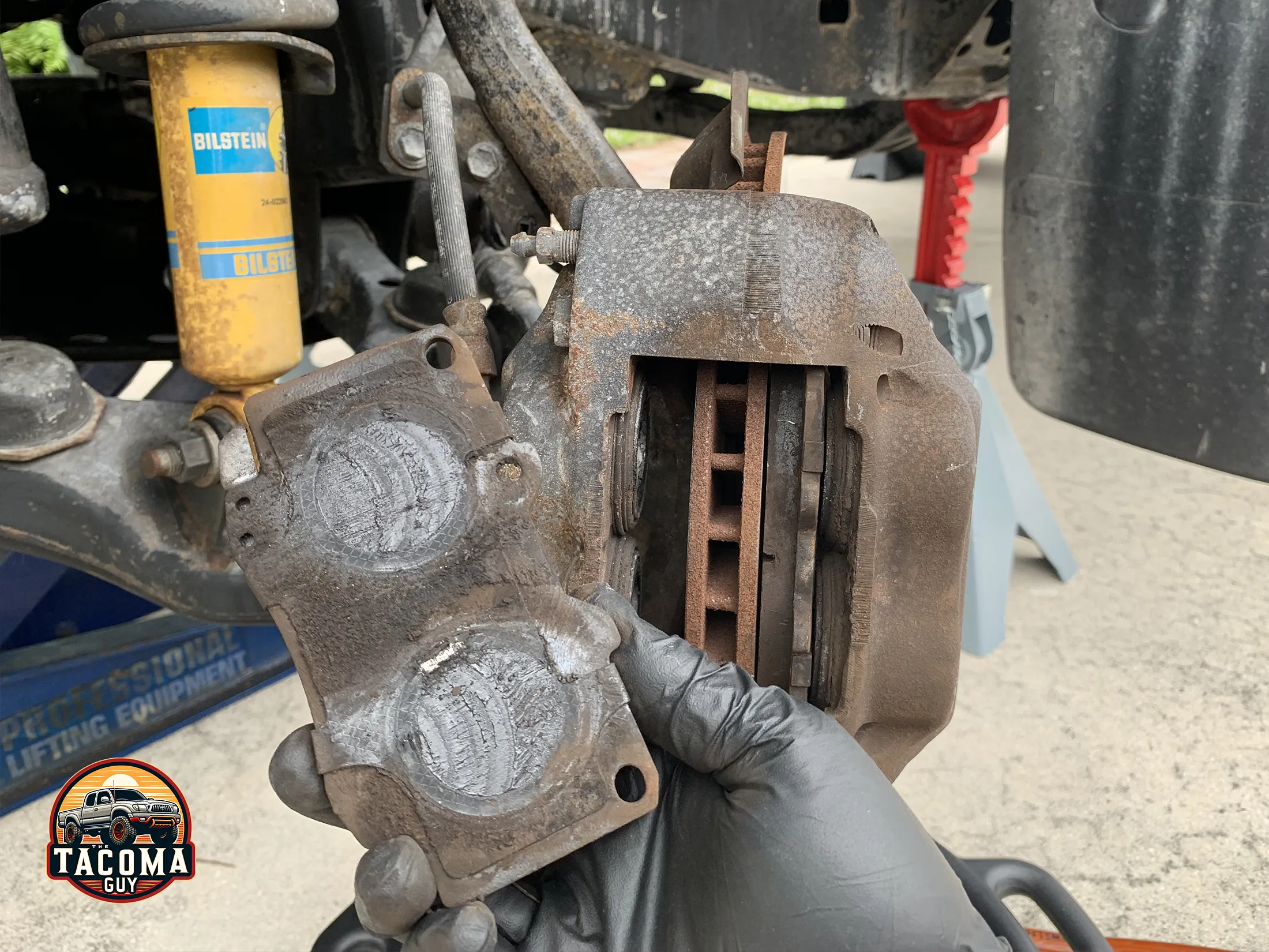 Taking old brake pads out of a gen 1 toyota tacoma brake caliper