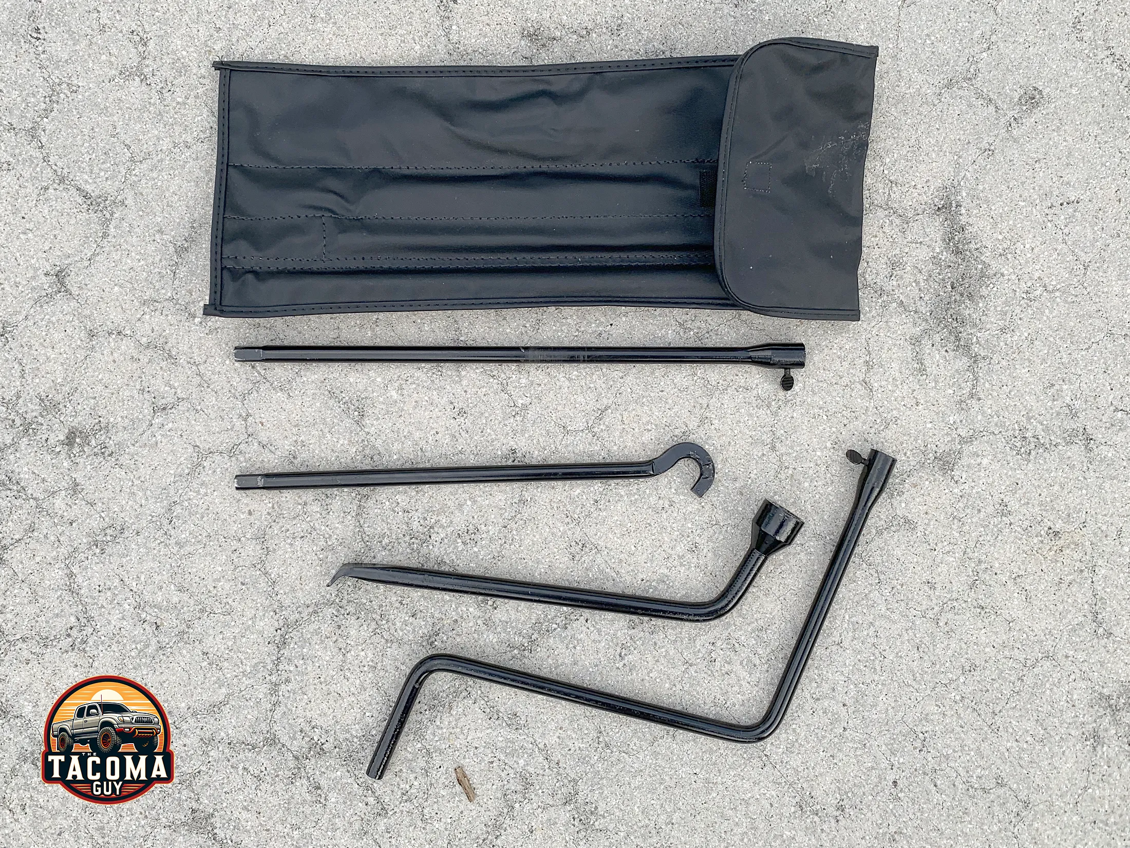 An OEM Toyota Tacoma Spare Tire Jack Handle and Lug Wrench Kit