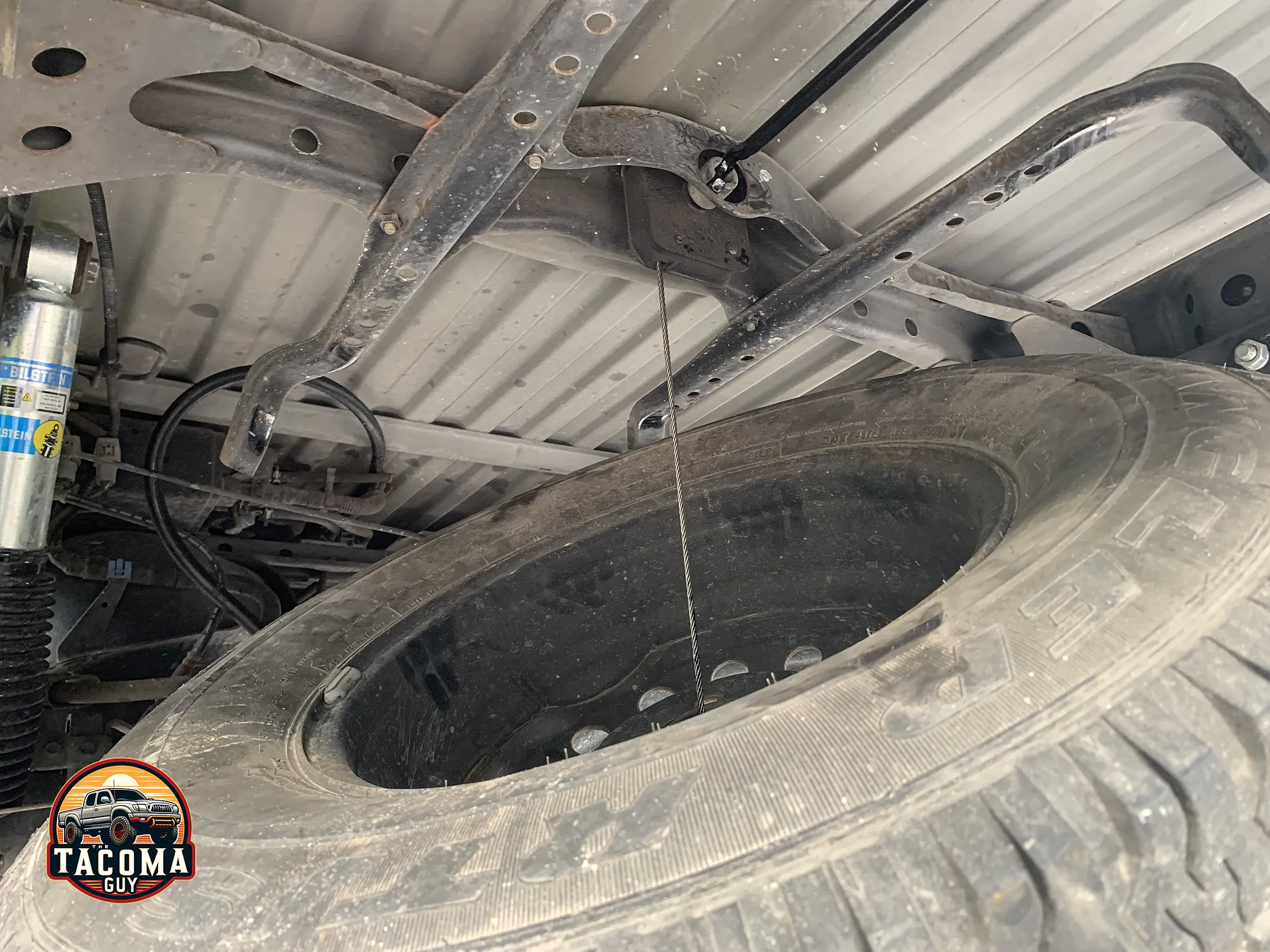 The toyota tacoma spare tire being lowered