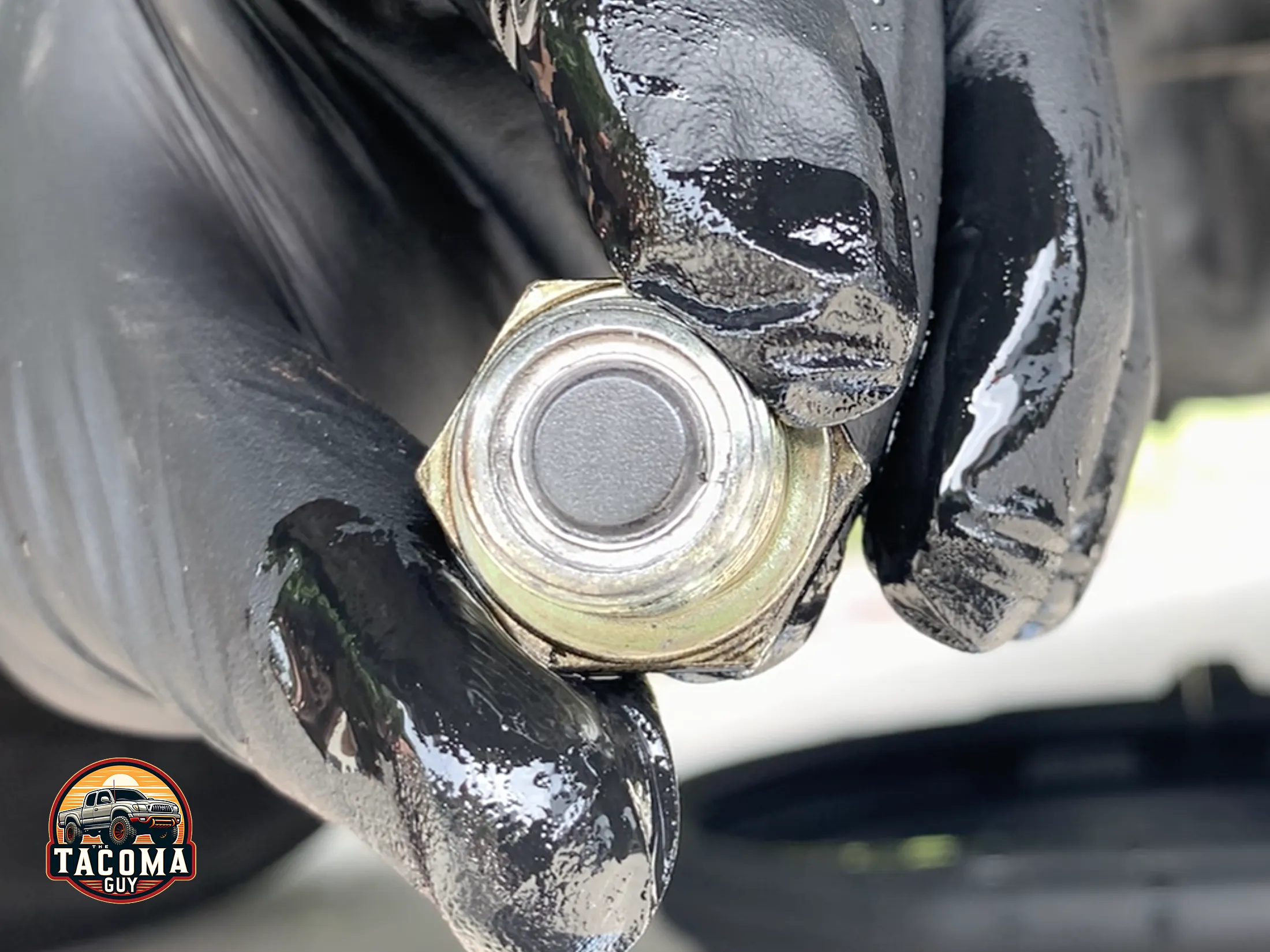 A clean magnet attached to the drain plug of the rear differential of a 2004 toyota tacoma