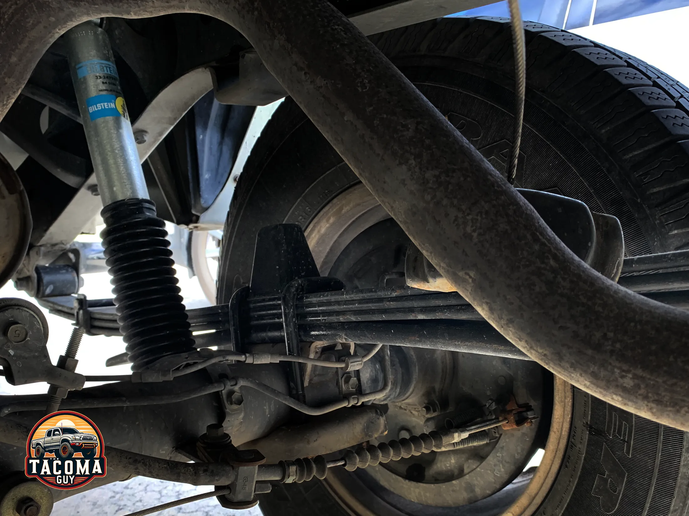 Close-up photo of a Bilstein 5100 shock absorber and General Springs 4x4 / Prerunner Heavy Duty rear leaf spring, with 4(3/1) leaves (part number 90-237HD)