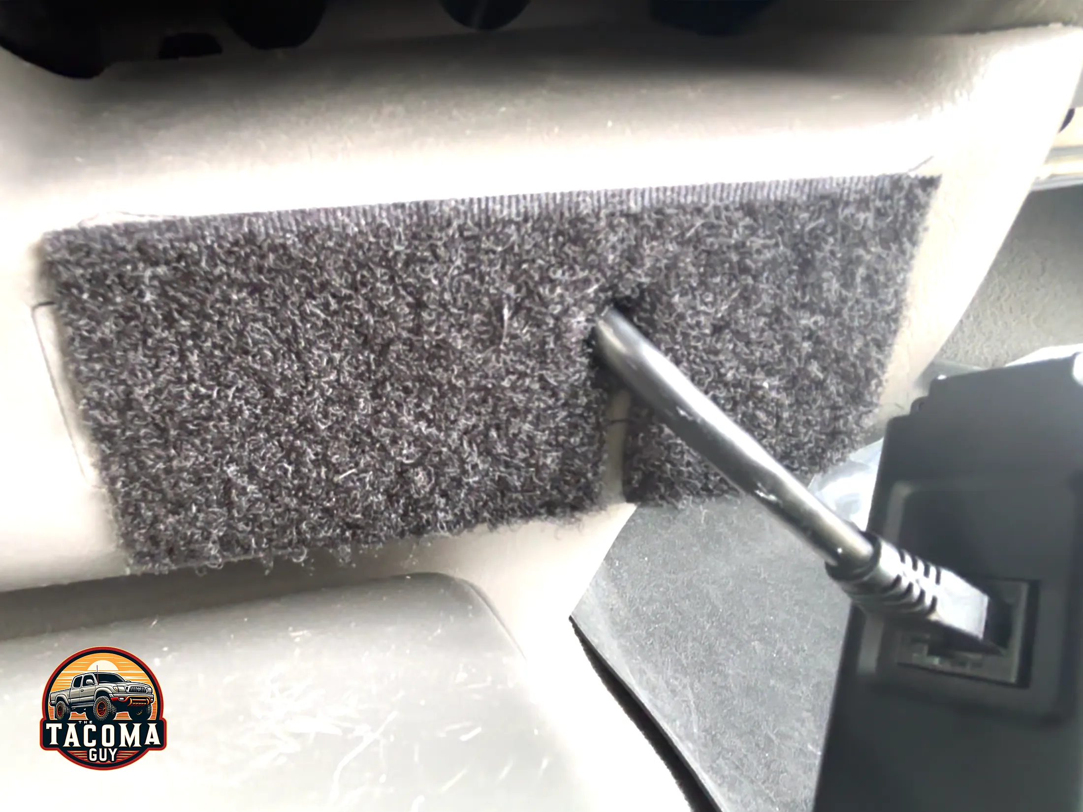 Where the velcro is mounted on the lower dash before placing the scan gauge II. 