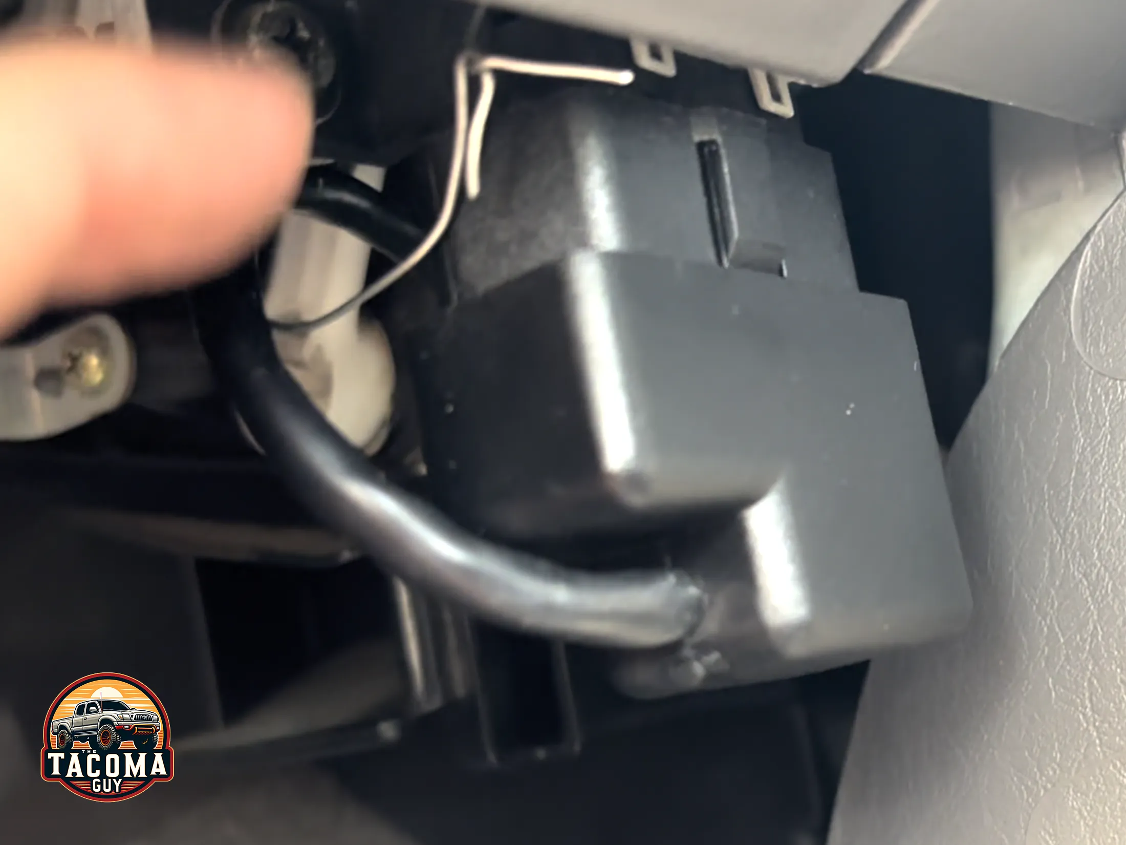 Closeup of the OBD-II port with the Scan Gauge II plugged into it